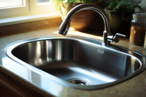 Photo of a new stainless steel kitchen sink.  Topic of the page: Effects of Hard Water in Your Home